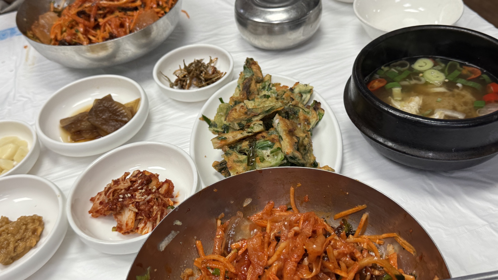 Full table spread at Donghae Mulhoe with pajeon pancake and banchan