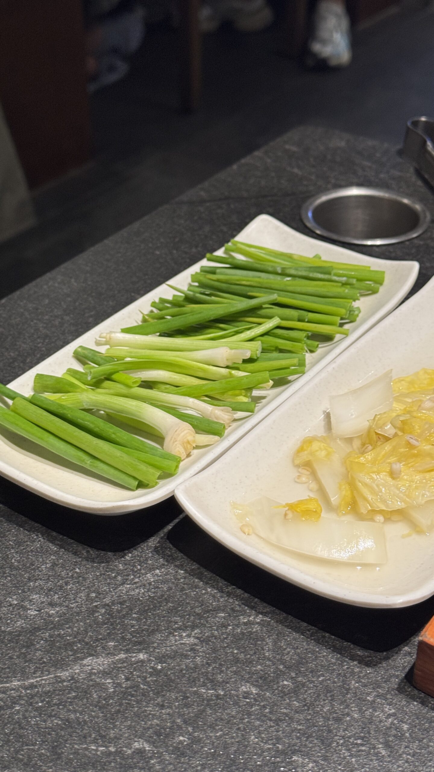 Green onion and pickled daikon side dishes at Gilchon Busan