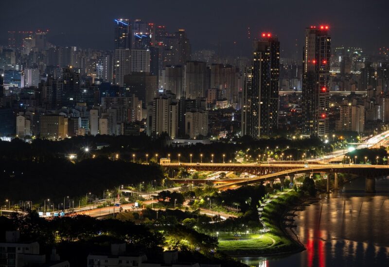 Gwangan Bridge lit up at night above Busan's Marine City skyline, the signature view seen from Hwangnyeongsan Observatory